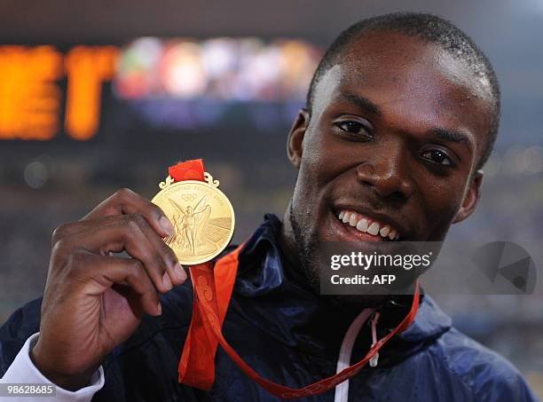 LaShawn Merritt of the United States poses with his gold medal on the podium after the men's 400m final at the National Stadium in the 2008 Beijing Olympic Games on August 21, 2008.  LaShawn Merritt of the United States won the men's 400 metres Olympic title here on Thursday timing 43.75 seconds, the fifth fastest time ever. The 22-year-old beat home defending champion Jeremy Wariner of the United States (44.74sec) while compatriot David Neville stumbled over the line to nick the bronze (44.80sec) off the Bahamas' Christopher Brown.    AFP PHOTO / FABRICE COFFRINI (Photo credit should read FABRICE COFFRINI/AFP via Getty Images)